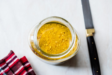Jar Of Peanut Butter with Knife for Breakfast on Marble Surface.