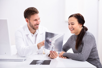 Doctor Showing Knee X-ray To Patient