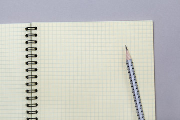 Notepad or notebook with pencil on gray background. Concept for education, business photo