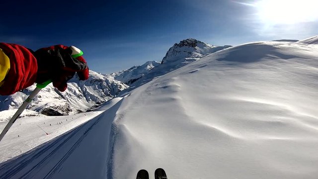 winter freeride skiing in powder fresh snow in alps on sunny day gopro chest mount