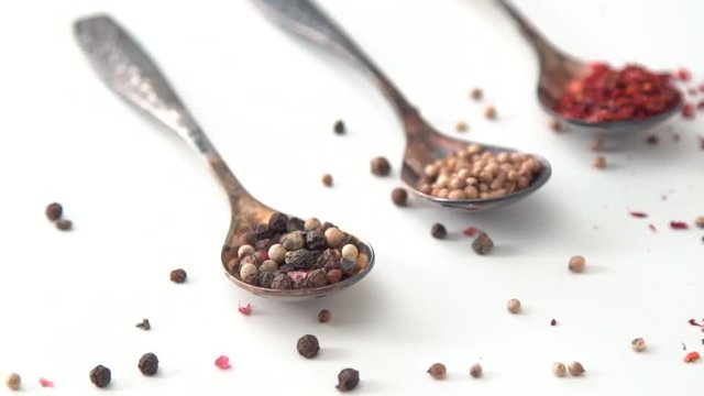  spices on a spoon, on a white table