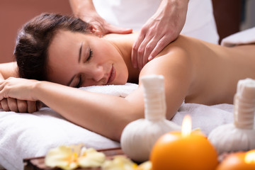 Fototapeta na wymiar Therapist Massaging Woman's Back