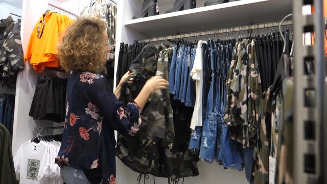 Woman Shopping For Clothes At Clothing Store