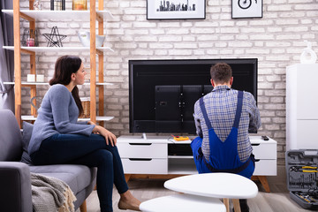 Technician Repairing Television
