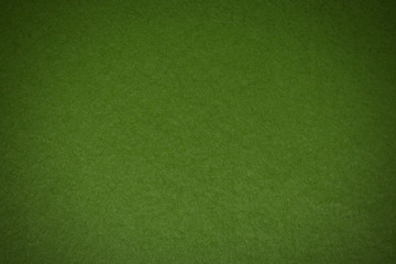 Green felt background, fabric surface texture,vignette