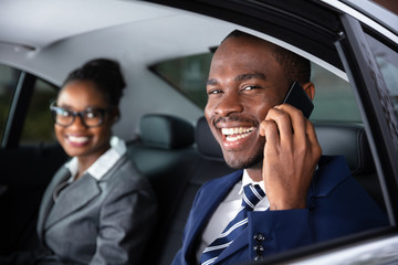 Businessman Sitting Inside Car Talking On Cellphone