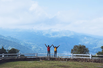 Fototapeta premium Couples travel nature at sheep farm at Doi Pha Tang, Doi Inthanon National Park, Chom Thong, Chiang Mai, Thailand