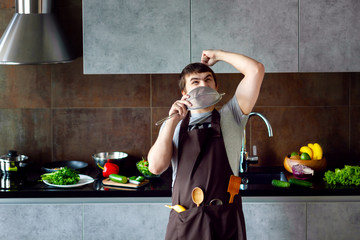 Funny angry loser man male guy with metal sieve, frying pan, wooden kitchen utensils and apron...