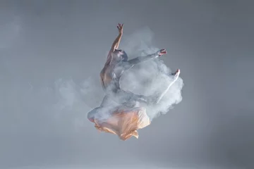 Gordijnen Elegant woman female girl ballerina dancer in beige dress dancing, making performance and dance element in fog dust smoke fume on isolated grey background scene. Dancing in cloud concept © Monstar Studio