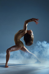 Dancing in cloud concept. Muscle brunette beauty female girl adult woman dancer athlete in fog...