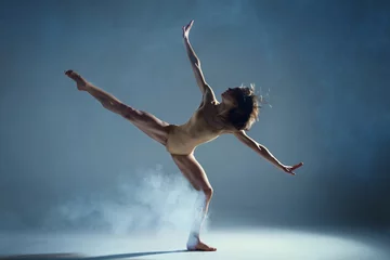 Foto op Canvas Dancing in cloud concept. Muscle brunette beauty female girl adult woman dancer athlete in fog smoke fume wearing dance bodysuit making stretches dance element performance on isolated grey background © Monstar Studio