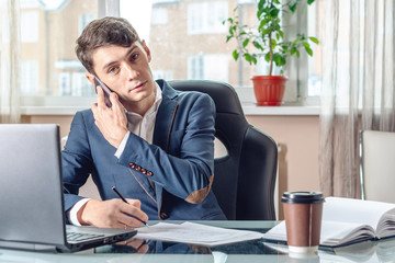 Businessman sitting at the table signing documents in the office. Concept of transactions with securities