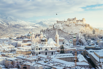 Fototapeta premium Panorama of Salzburg in winter: Snowy historical center, sunshine