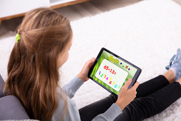 Girl Solving Math On Digital Tablet