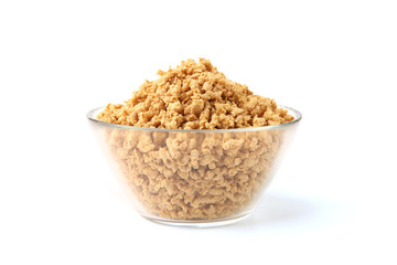 Raw soy mince in glass bowl isolated on white background. Dry soya mince meat.