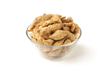 Raw soy chunks in glass bowl isolated on white background. Dry soya pieces meat used in vegetarian and vegan food.