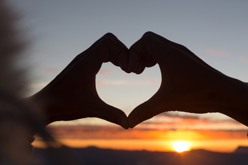 Woman making heart shape during sun rise, God is love concept, Heart shape, Mountain tourism,...