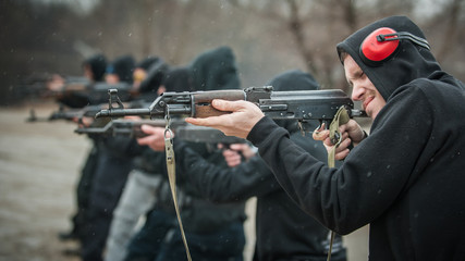 Large team action training with rifle machine gun. Shooting range