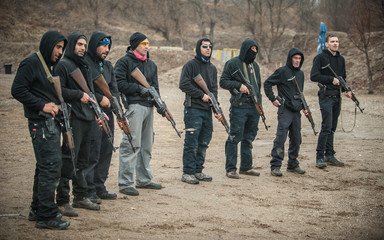 Large team action training with rifle machine gun. Shooting range