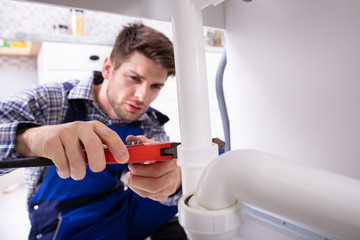 Plumber Repairing Sink Pipe