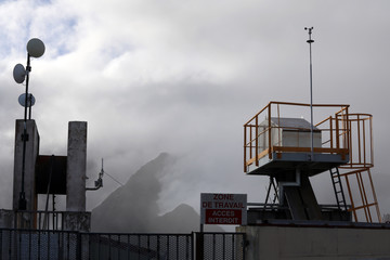 On the background of the mountains in the fog is a station for communicating