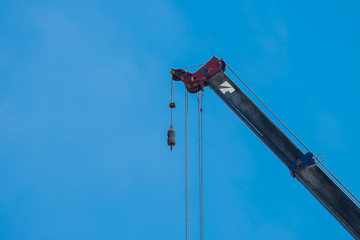 Crane Hook lifting  for construction on blue sky,steel hook and chain, copy space