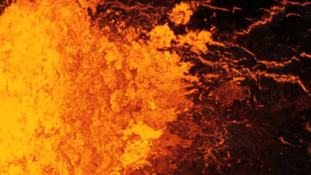Aerial of active volcano erupting red hot magma