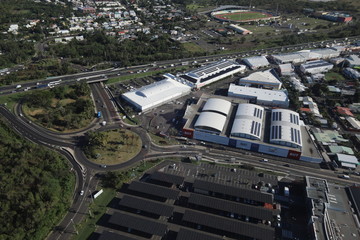 Top view on buildings, parking, lots of cars and roadway