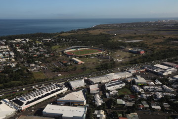 Top view on buildings, parking, lots of cars and roadway