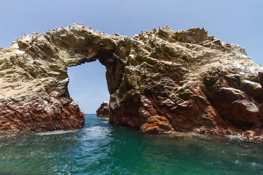 Rock formation with arch on an islet of the Ballestas Islands (Paracas, Peru)