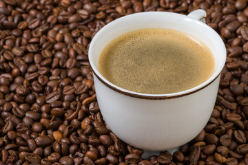 white cup of coffee with beans