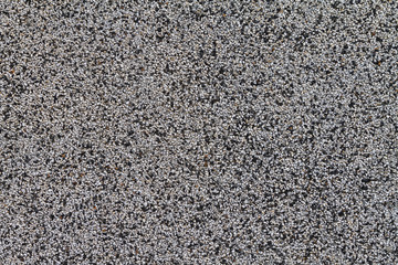 The crushed stone surface of the wall. Close up. Background.