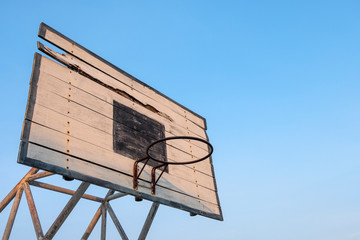 Fototapeta na wymiar old basketball backboard, basketball hoops with blue sky background.