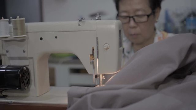 Old Asian Mother Use Sewing Machine To Repair Torn Clothes 4K