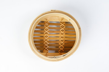 Wooden bamboo dim sum steamer on white background