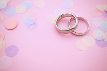 Wedding rings on pastel colors with copy space