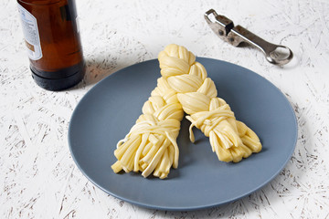 Cheese on a plate on a gray plate and beer. Sulguni cheese