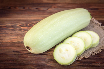 Zucchini on wooden background.