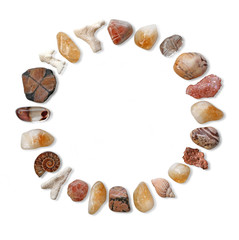 Circle of earth healing stones -  Some of nature's beautiful warm coloured stones laid in a neat circle on a white background creating a border 