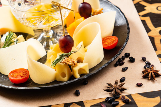 Cheese plate on the black table -  Image.
