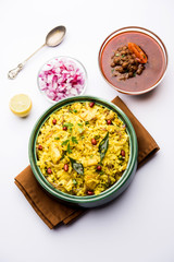 Aloo/Kanda Poha or Tarri Pohe with spicy chana masala/curry. selective focus