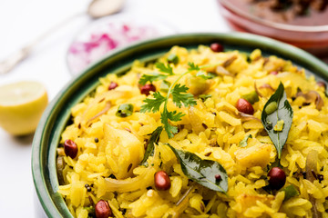 Aloo/Kanda Poha or Tarri Pohe with spicy chana masala/curry. selective focus