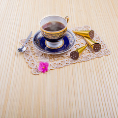 A Cup of hot coffee with delicious sweets on a light background 2