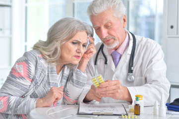 Portrait of senior doctor with elderly patient