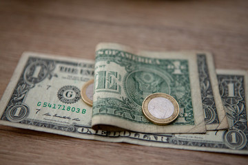 Euro coins on US paper US dollars