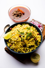 Aloo/Kanda Poha or Tarri Pohe with spicy chana masala/curry. selective focus
