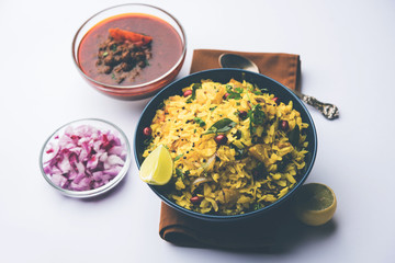 Aloo/Kanda Poha or Tarri Pohe with spicy chana masala/curry. selective focus