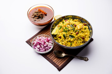 Aloo/Kanda Poha or Tarri Pohe with spicy chana masala/curry. selective focus