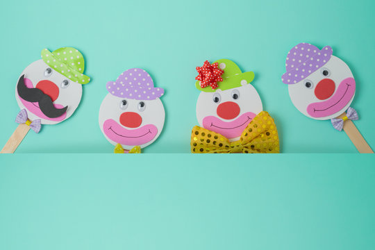 Jewish holiday Purim background with cute paper clowns characters.