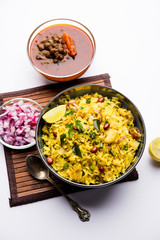 Aloo/Kanda Poha or Tarri Pohe with spicy chana masala/curry. selective focus